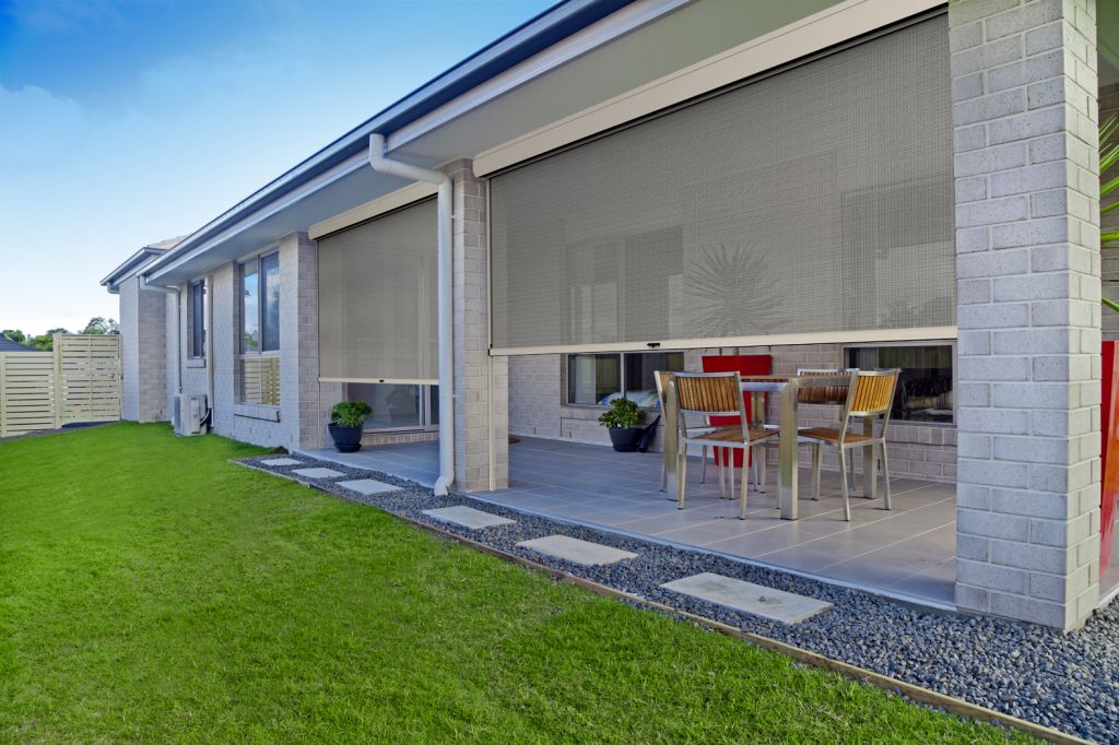 elegant ziptrak outdoor bling on Gold Coast home dividing entertainment area and backyard.